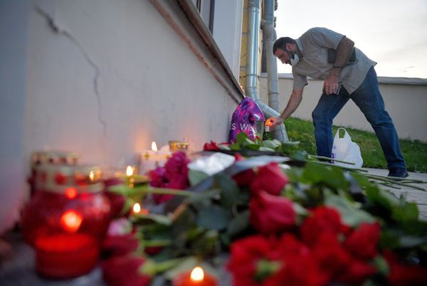 Мужчина возлагает цветы к посольству Ливана в Москве в память о жертвах взрыва - Sputnik Азербайджан