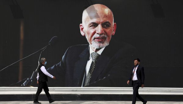 Люди проходят пере плакатом президента Афганистана Ашрафа Гани, фото из архива - Sputnik Азербайджан