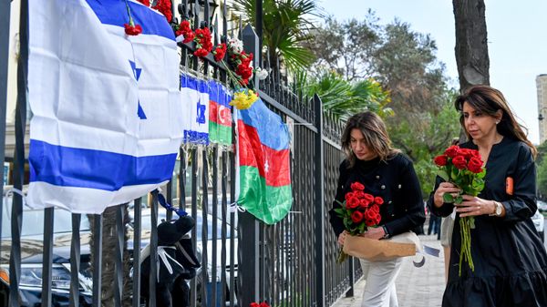 Люди несут к посольству Израиля в Баку цветы после атаки движения ХАМАС - Sputnik Азербайджан