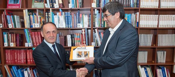 Руководитель Sputnik Азербайджан Азиз Алиев передает директору Президентской библиотеки Маилу Ахмедову альбом-справочник, выпущенный по результатам интервью Ильхама Алиева генеральному директору МИА Россия Сегодня Дмитрию Киселеву - Sputnik Азербайджан