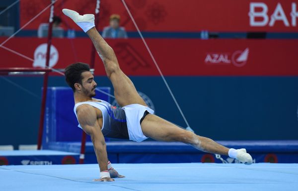 Финалы соревнований по спортивной гимнастике среди мужчин и женщин в вольных упражнениях, упражнениях на брусьях и кольцах, в опорном прыжке и на брусьях - Sputnik Азербайджан
