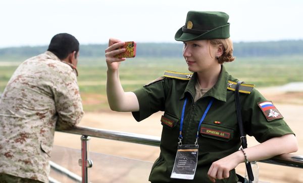 Зрительница фотографируется во время соревнований по танковому биатлону в рамках Армейских международных играх АрМИ-2017 на полигоне Алабино в Московской области - Sputnik Азербайджан