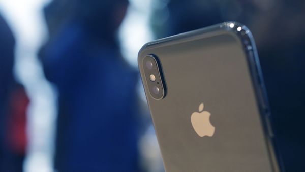 The Apple iPhone X sits on display at the new Apple Michigan Avenue store along the Chicago River Friday, Nov. 3, 2017, in Chicago. - Sputnik Азербайджан