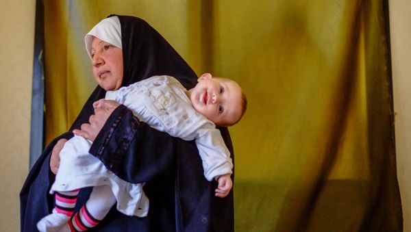 Женщина с ребенком - беженцы из Сирии - в одном из домов в городе Хальба на севере Ливана - Sputnik Азербайджан