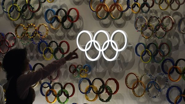 Посетитель показывает на недавно открывшийся Олимпийский музей Японии перед Олимпиадой в Токиo - Sputnik Азербайджан
