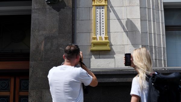 Молодые люди фотографируют термометр - Sputnik Азербайджан