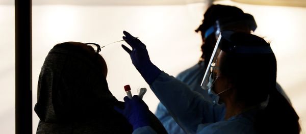 Medical personnel swab an employee’s nose at a drive-through testing site for coronavirus for employees at UW Medical Center Northwest in Seattle, Washington - Sputnik Азербайджан